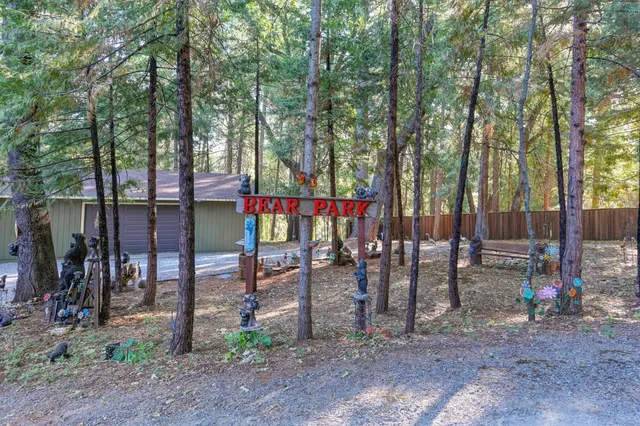 a view of road with house and trees in the background