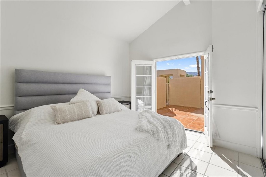 77 Lakeshore Drive Rancho Mirage, CA 92270 - Photo 12 of 25 a bedroom with a bed and a refrigerator