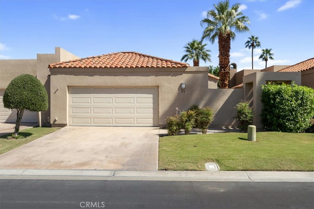 77 Lakeshore Drive Rancho Mirage, CA 92270 - Photo 2 of 25 a front view of a house with a yard