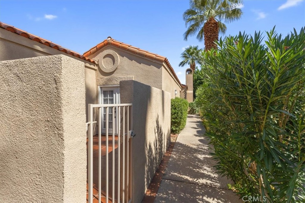 77 Lakeshore Drive Rancho Mirage, CA 92270 - Photo 3 of 25 a view of a pathway of a house with a small yard