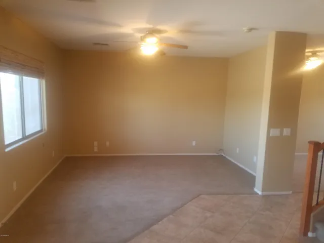 an empty room with windows and entrance