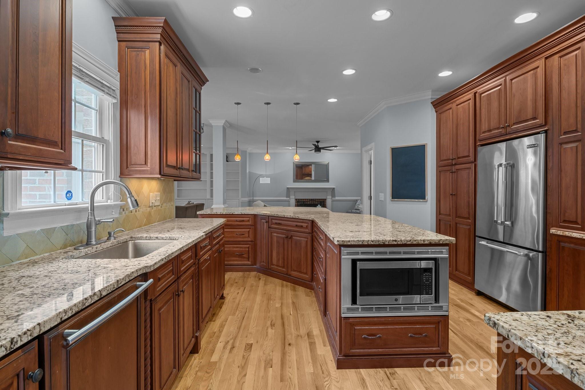 9717 Waterton Court Huntersville, NC 28078 - Photo 14 of 47 a kitchen with stainless steel appliances granite countertop a sink stove and refrigerator