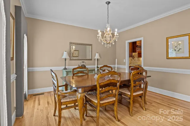 a view of a dining room with furniture and chandelier