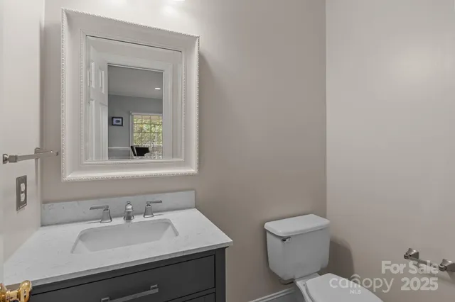 a bathroom with a sink toilet and mirror