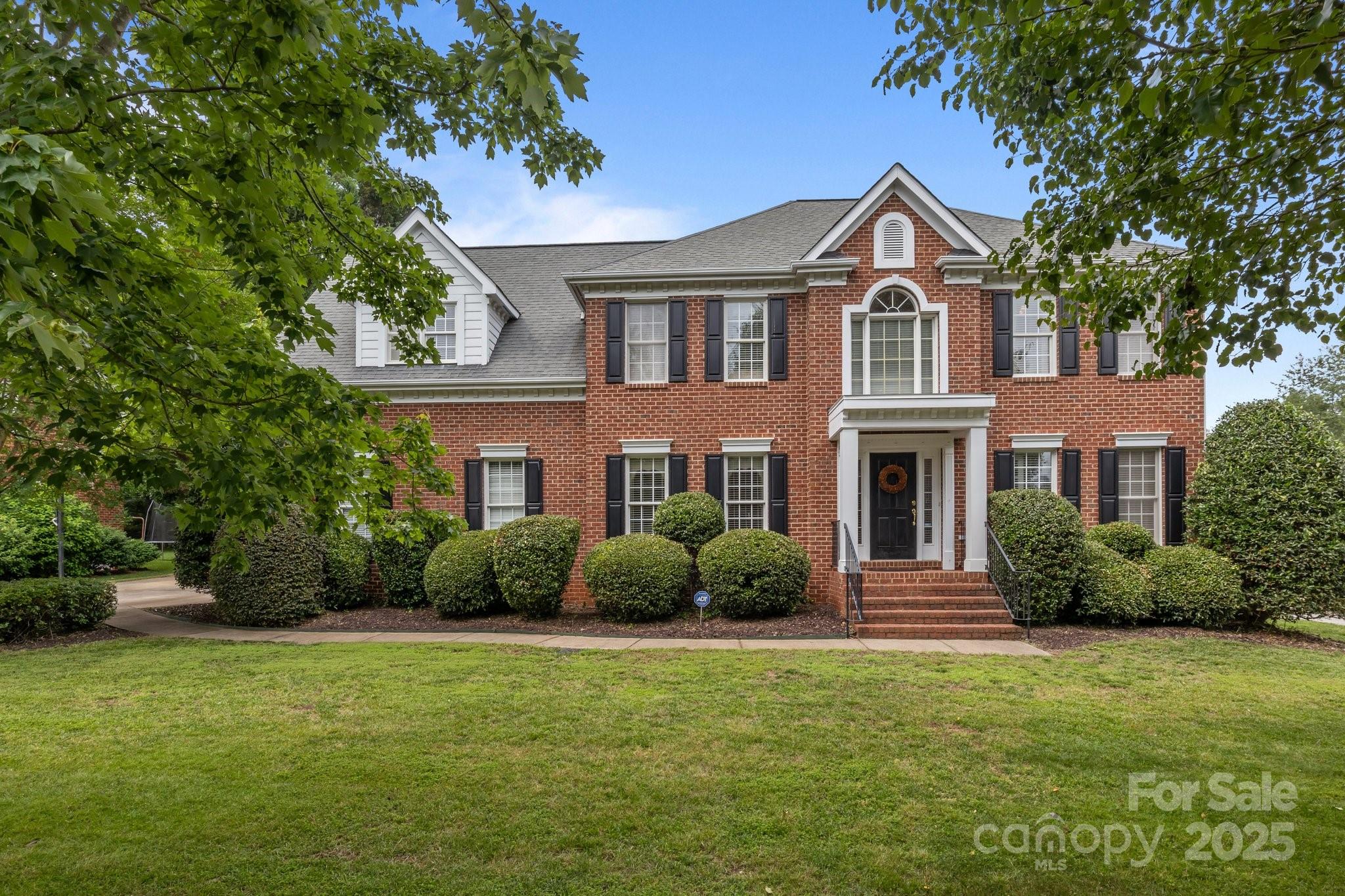 9717 Waterton Court Huntersville, NC 28078 - Photo 2 of 47 a front view of a house with a garden