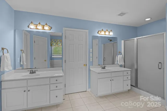 a bathroom with a sink double vanity and a mirror