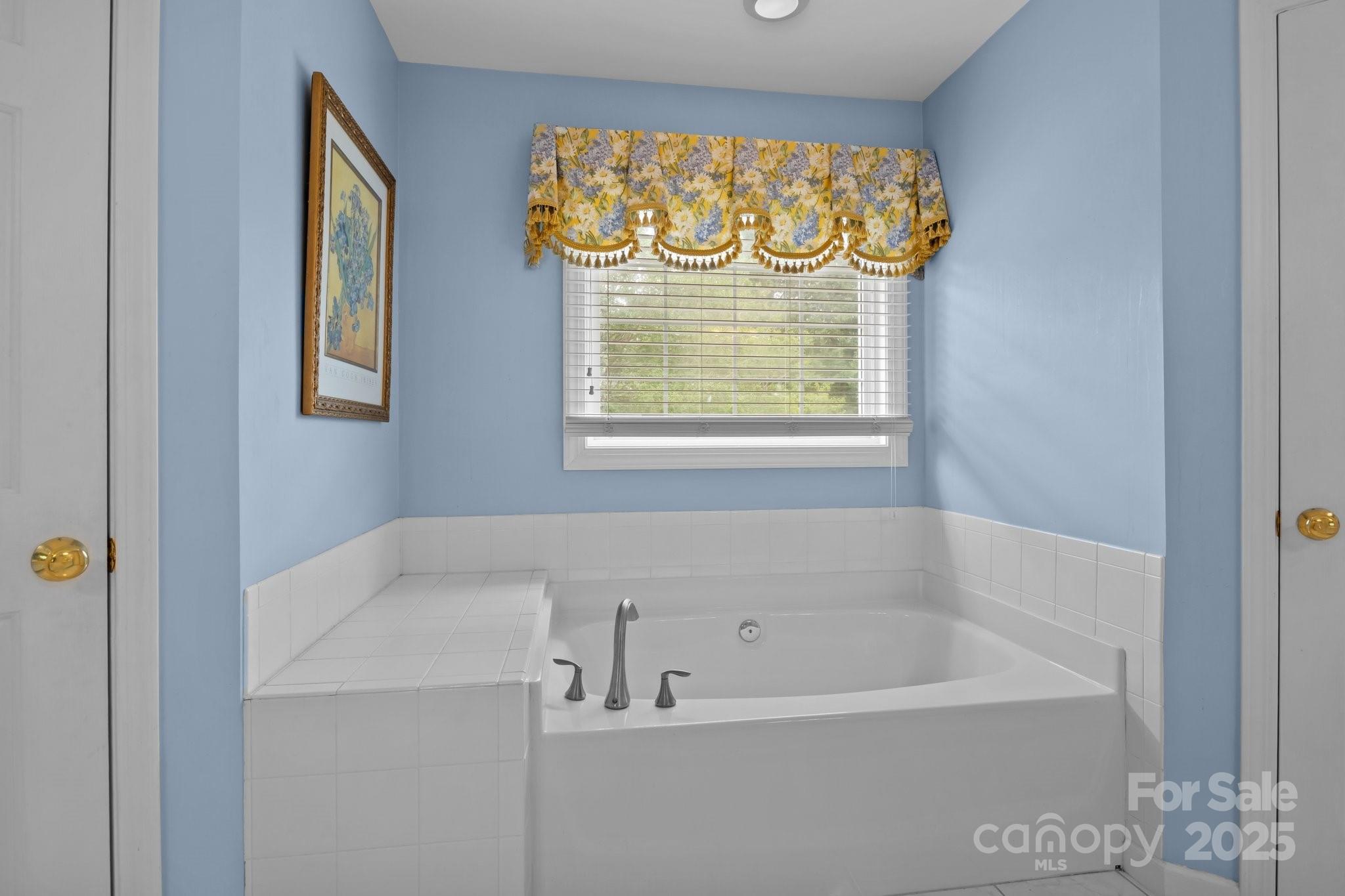 9717 Waterton Court Huntersville, NC 28078 - Photo 24 of 47 a bathroom with a bathtub and a shower