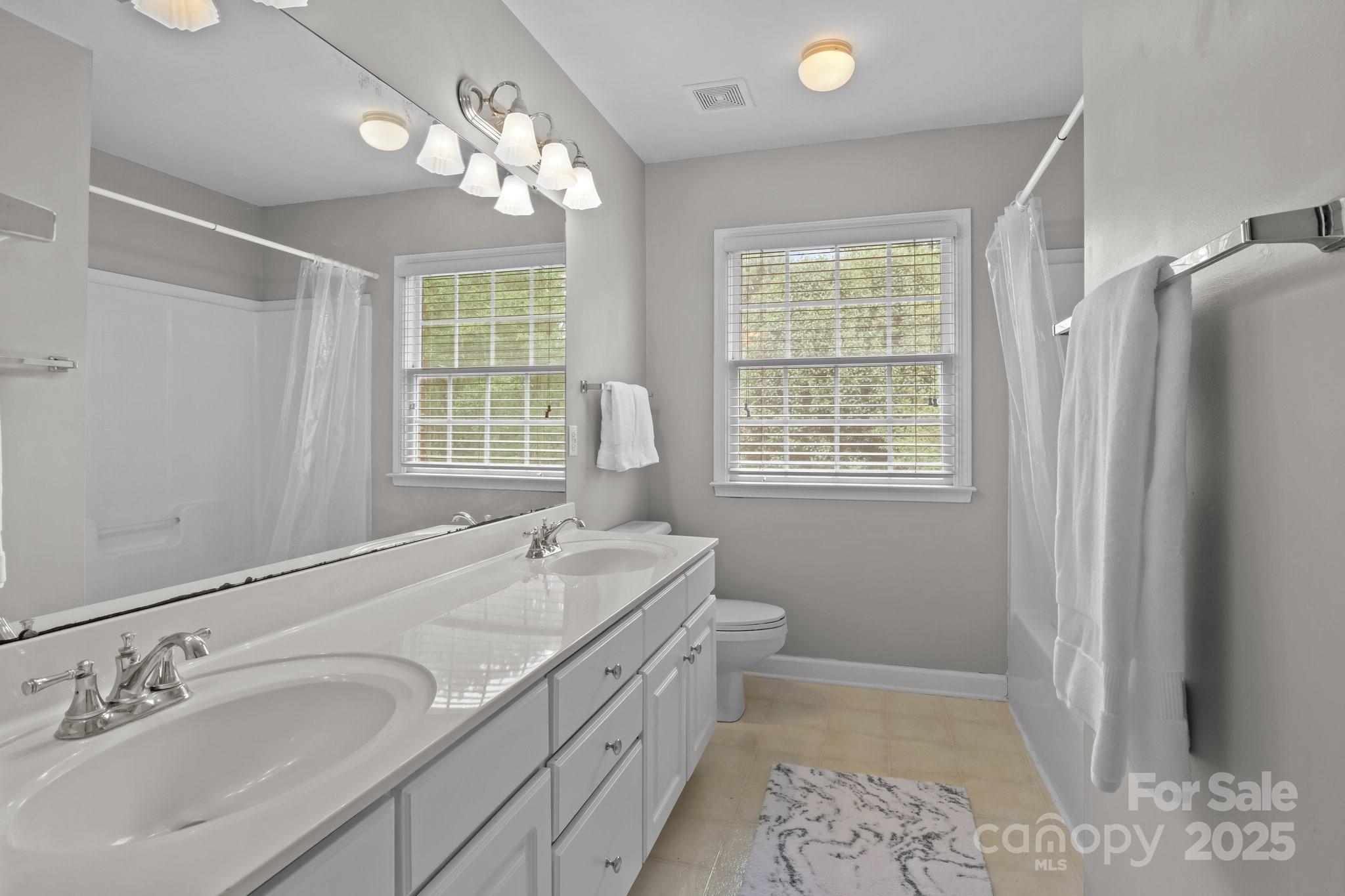 9717 Waterton Court Huntersville, NC 28078 - Photo 28 of 47 a spacious bathroom with double vanity and a mirror