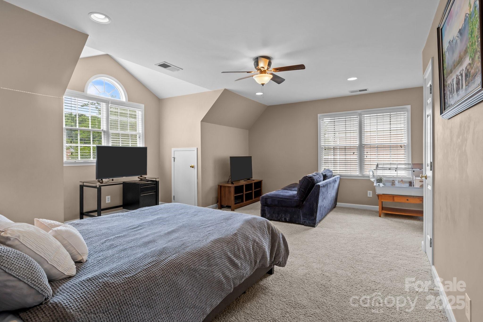 9717 Waterton Court Huntersville, NC 28078 - Photo 29 of 47 a spacious bedroom with a bed a couch and dresser