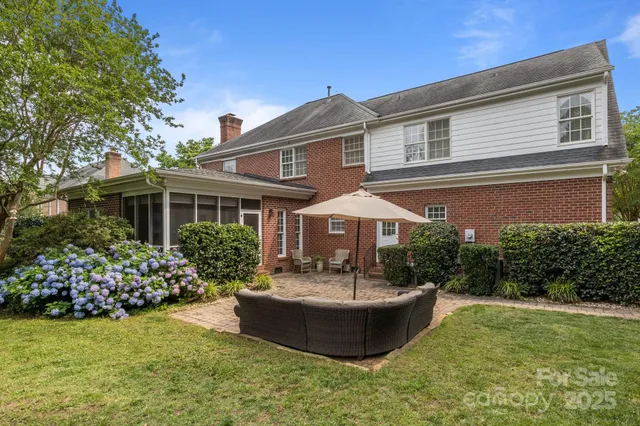 a front view of a house with a yard table and chairs