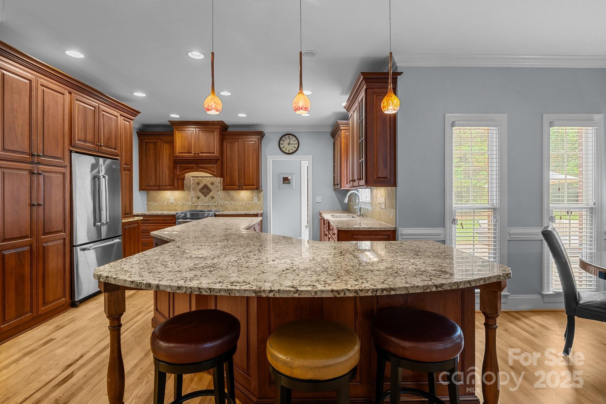 9717 Waterton Court Huntersville, NC 28078 - Photo 10 of 47 a kitchen with stainless steel appliances granite countertop a kitchen island a table and chairs