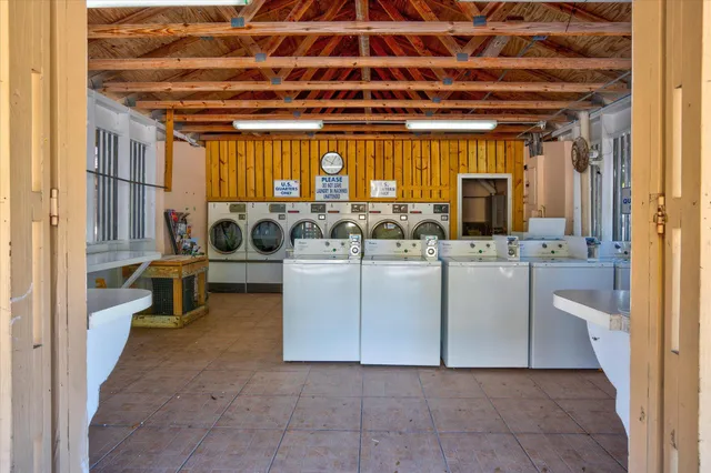 a view of a house with a wooden deck and a yard