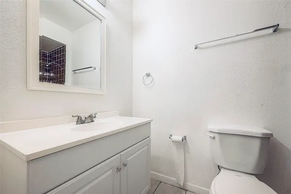 a bathroom with a sink toilet and a mirror