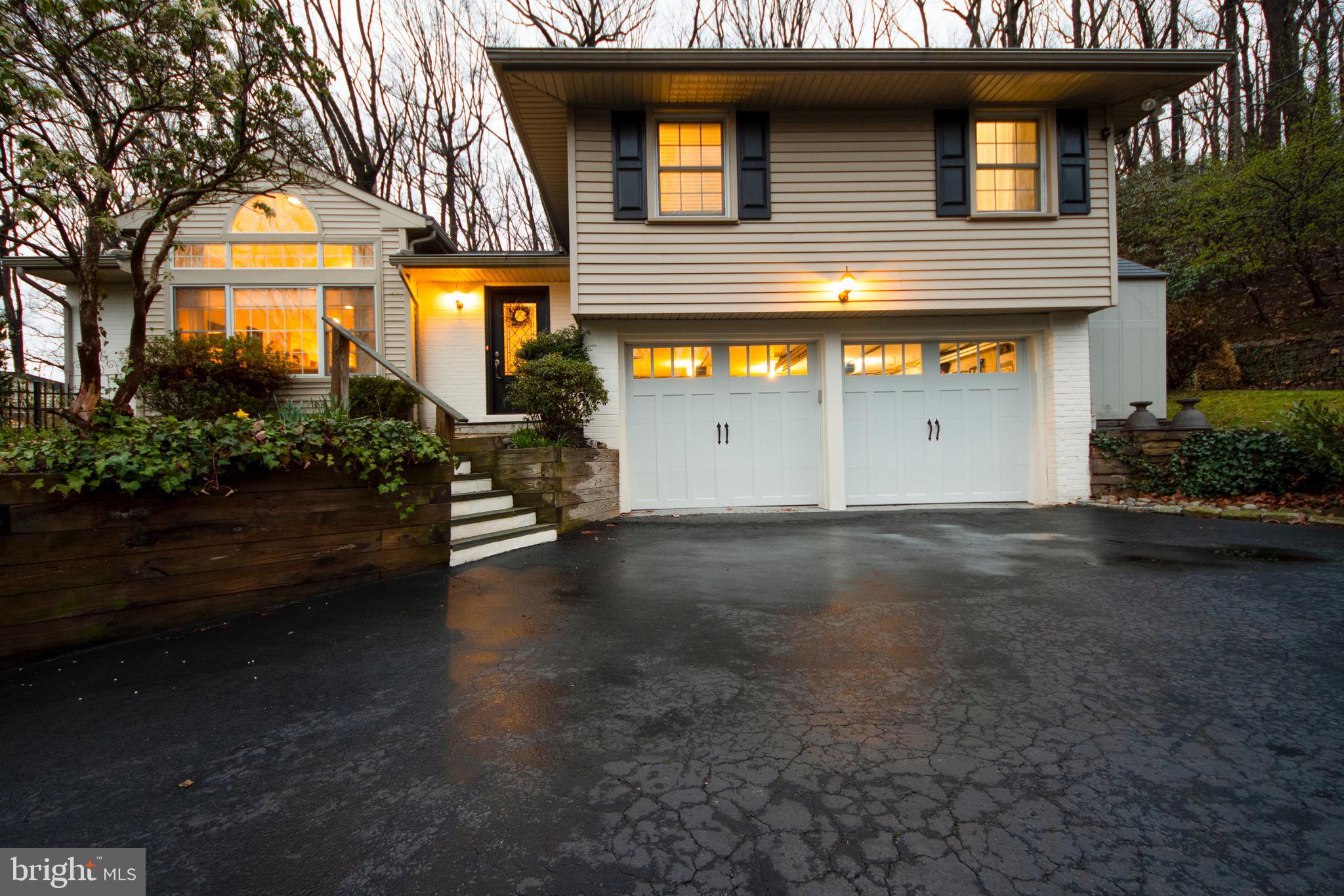 174 Pugh Road Wayne, PA 19087 - Photo 2 of 42 a front view of a house with a garden
