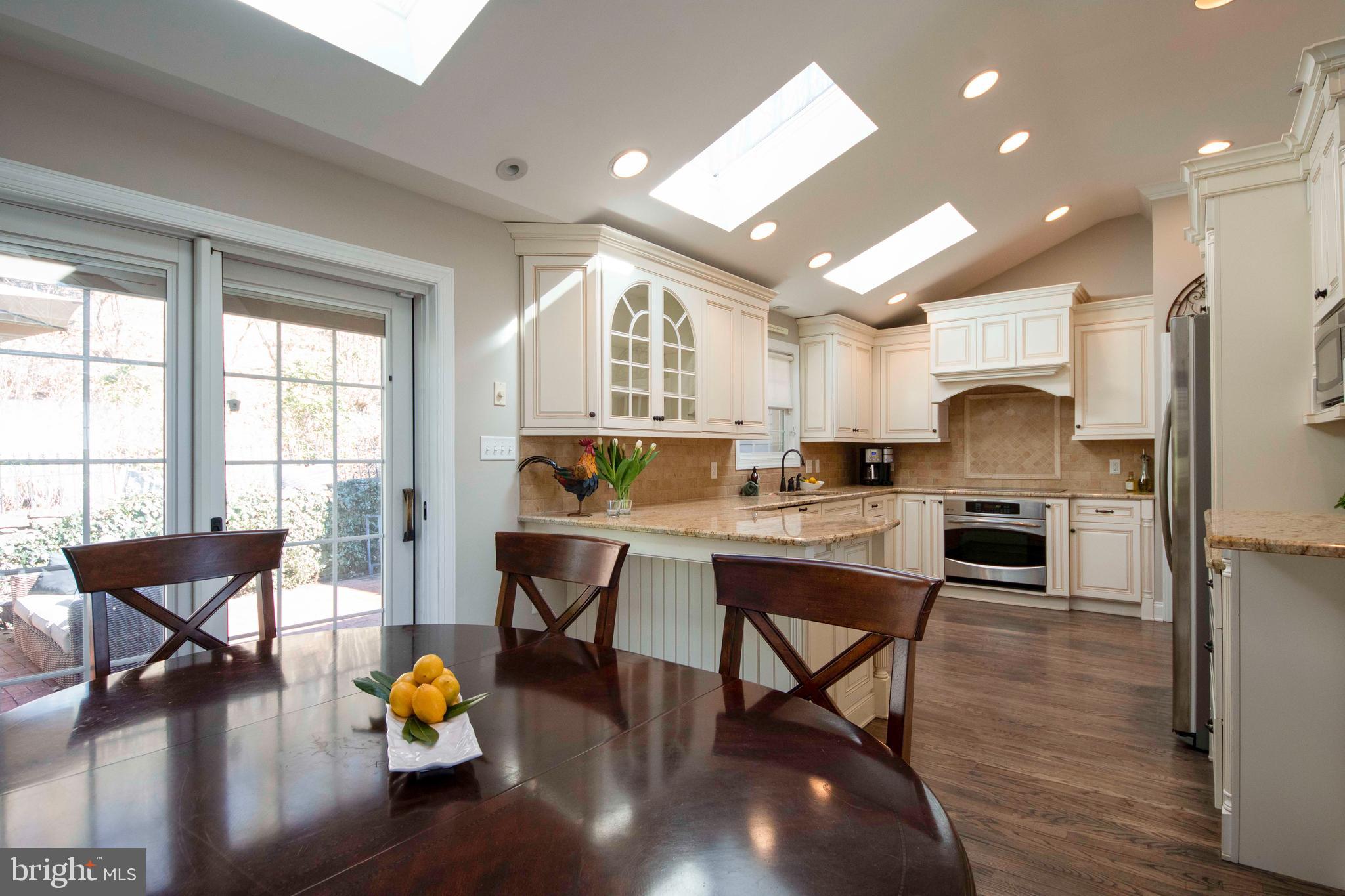 174 Pugh Road Wayne, PA 19087 - Photo 14 of 42 a kitchen with a dining table chairs and wooden floor