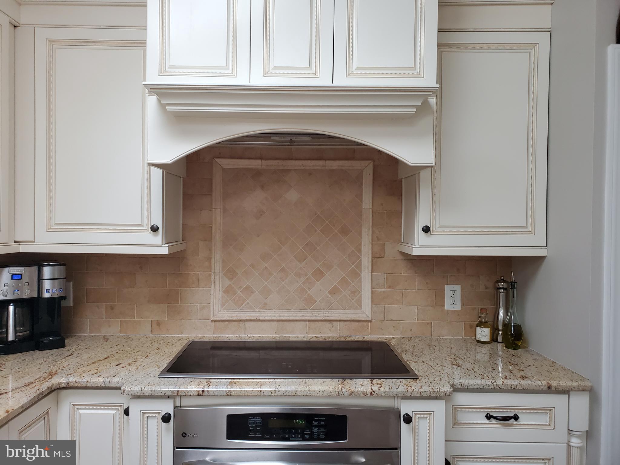 174 Pugh Road Wayne, PA 19087 - Photo 19 of 42 a kitchen with granite countertop white cabinets and stainless steel appliances