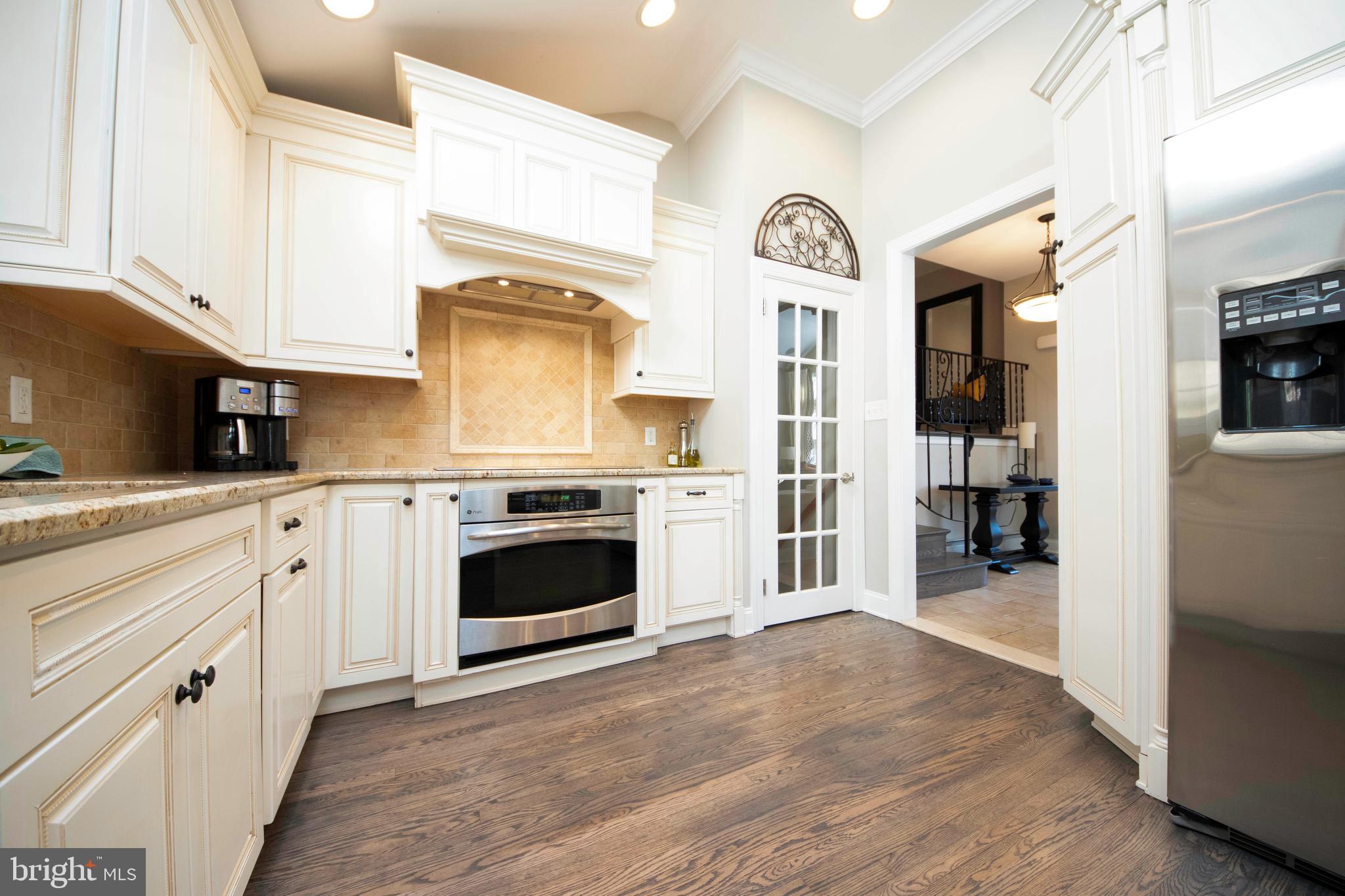 174 Pugh Road Wayne, PA 19087 - Photo 22 of 42 a kitchen with stainless steel appliances granite countertop a stove and a refrigerator