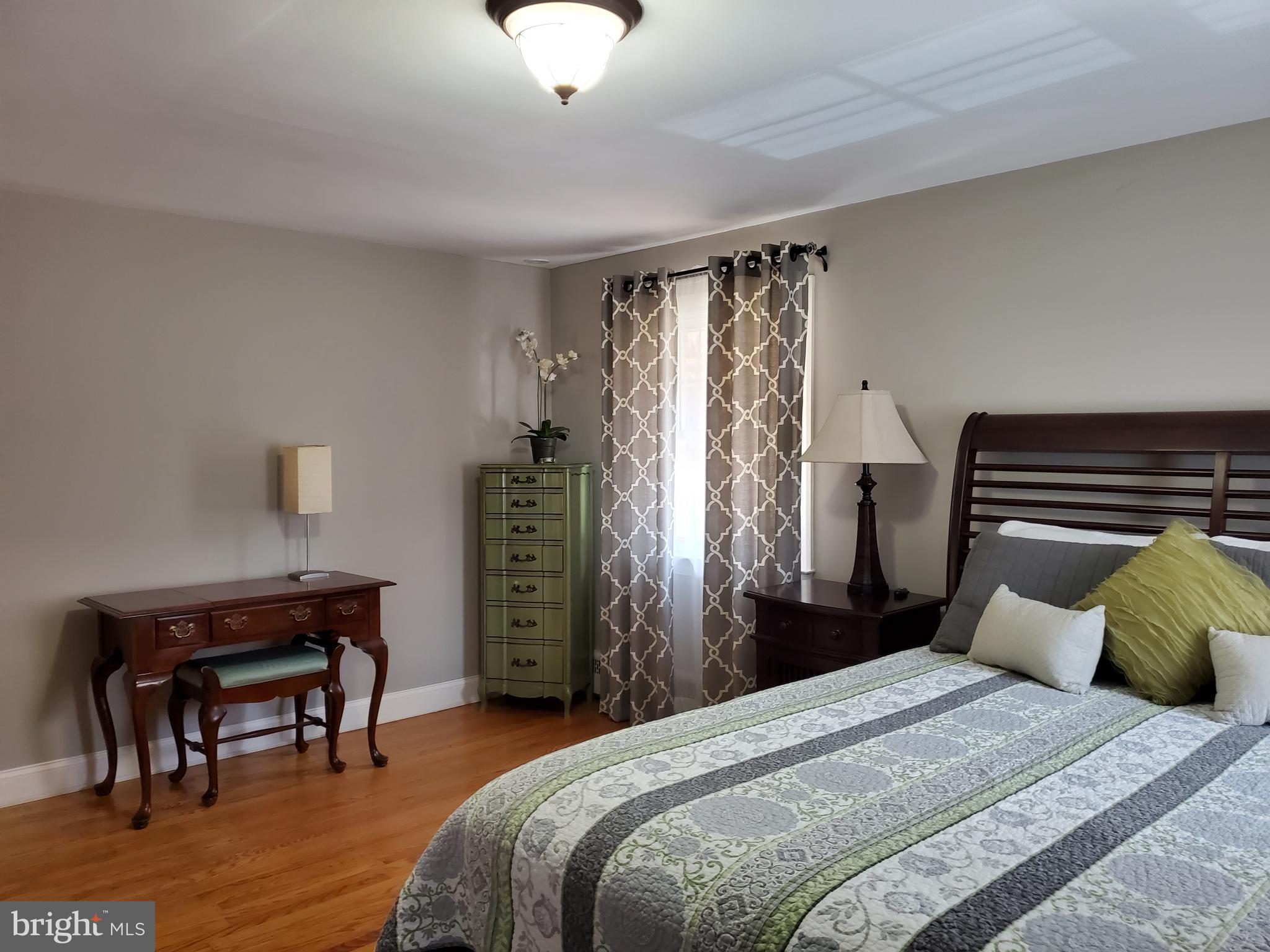 174 Pugh Road Wayne, PA 19087 - Photo 25 of 42 a bedroom with a bed and a chandelier