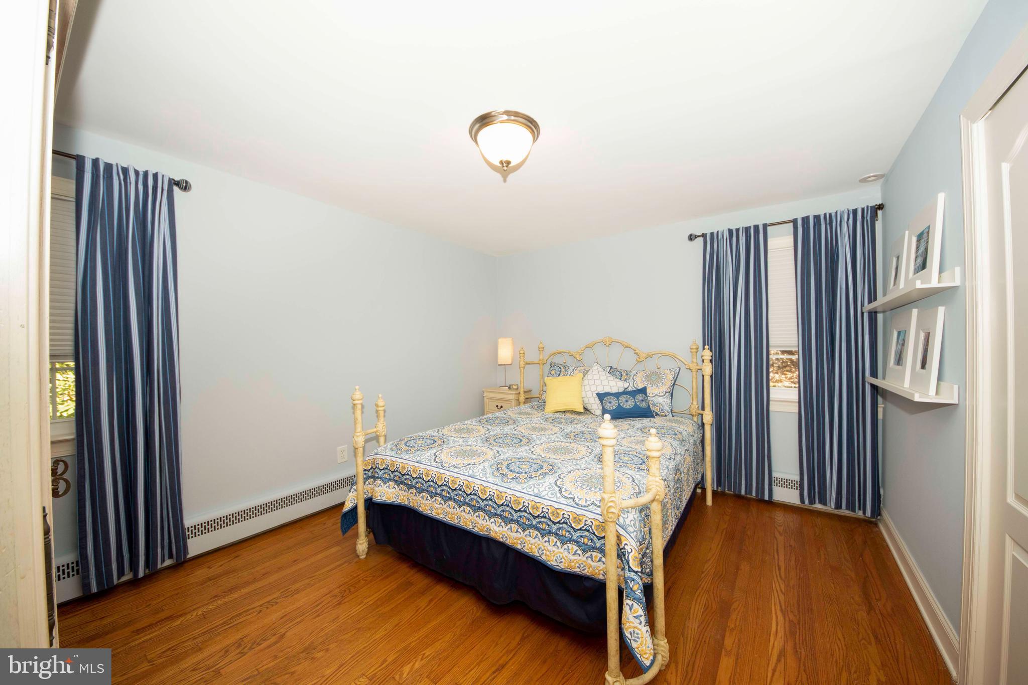 174 Pugh Road Wayne, PA 19087 - Photo 30 of 42 a room with a bed and a dresser next to a window