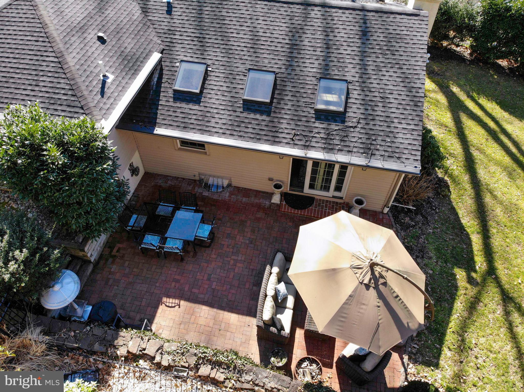174 Pugh Road Wayne, PA 19087 - Photo 39 of 42 a view of a patio with table and chairs with an umbrella and garden
