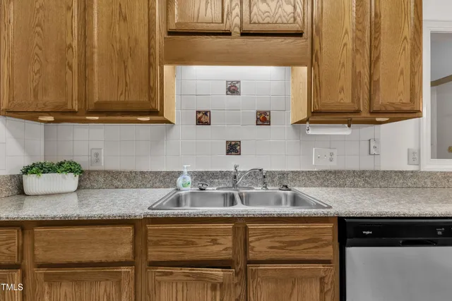 a kitchen with stainless steel appliances granite countertop a sink and a cabinets