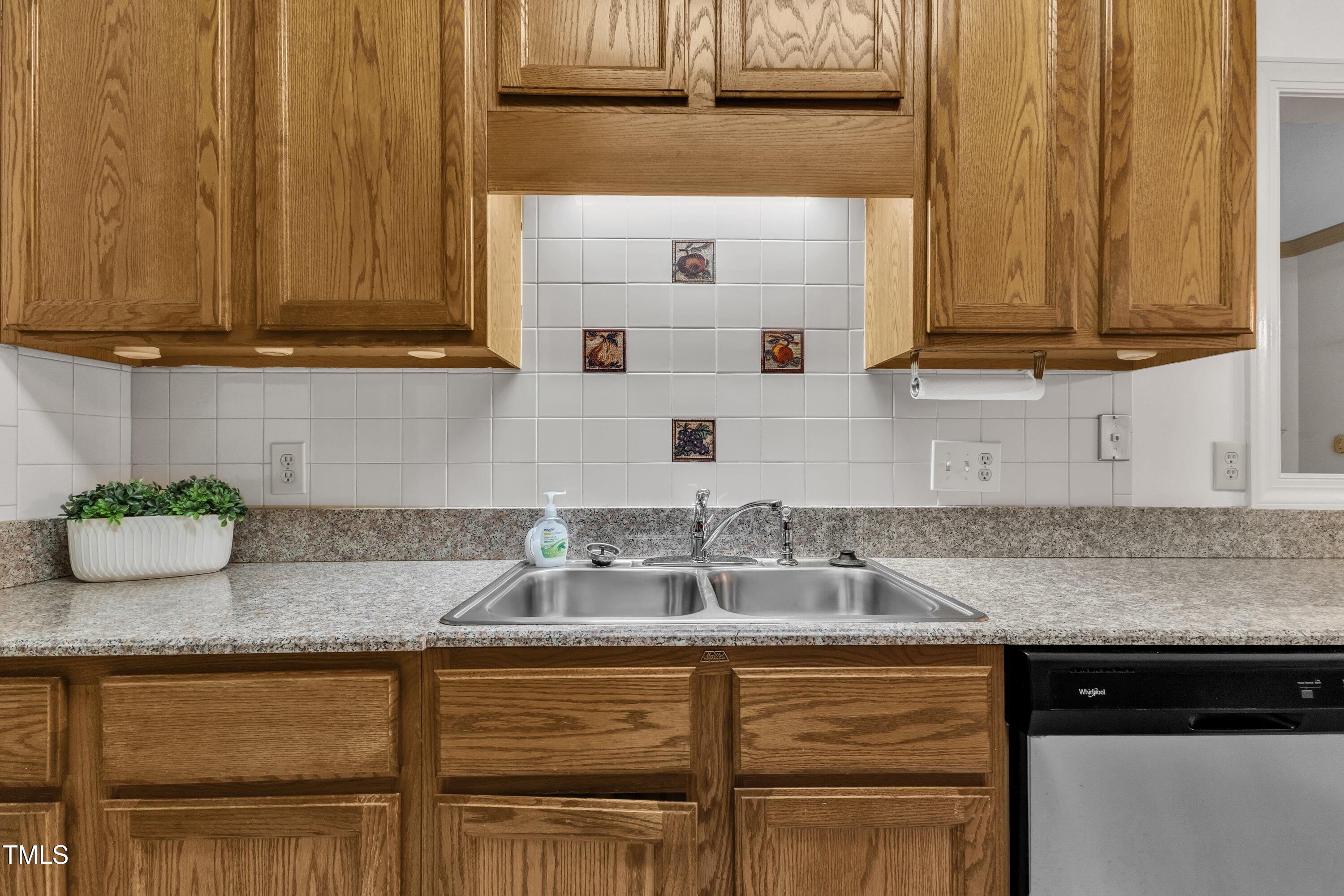 1210 Shadow Bark Court Raleigh, NC 27603 - Photo 11 of 32 a kitchen with stainless steel appliances granite countertop a sink and a cabinets