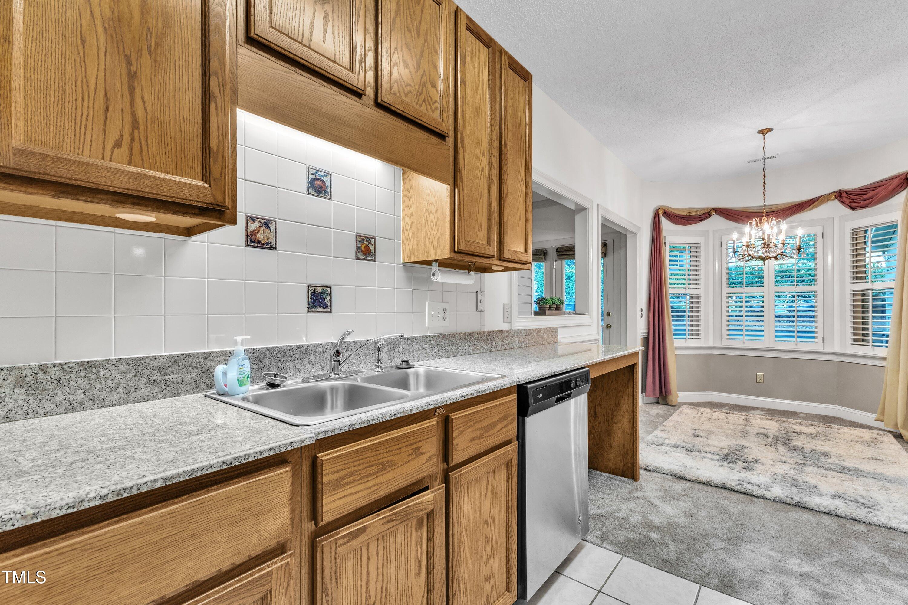 1210 Shadow Bark Court Raleigh, NC 27603 - Photo 12 of 32 a kitchen with a sink cabinets and window