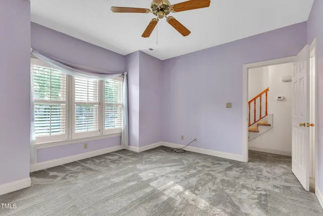 a view of entryway and hall with a chandelier fan