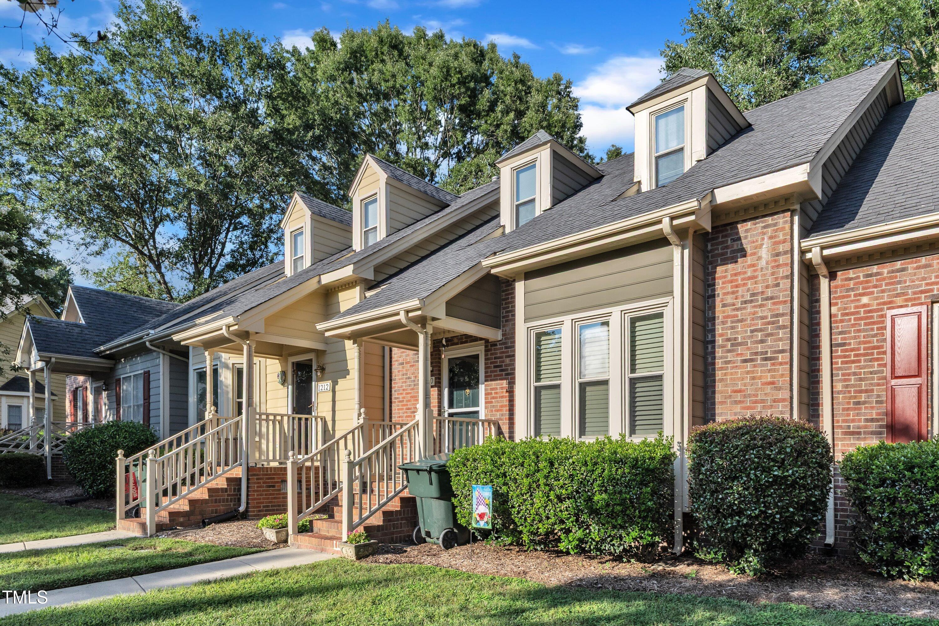 1210 Shadow Bark Court Raleigh, NC 27603 - Photo 2 of 32 a view of a white house next to a yard with plants and trees