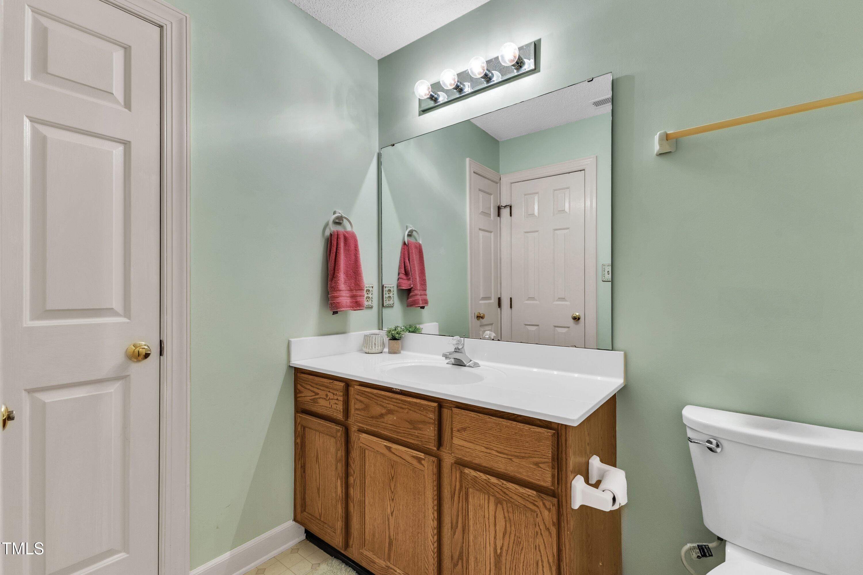 1210 Shadow Bark Court Raleigh, NC 27603 - Photo 25 of 32 a bathroom with a sink and a mirror