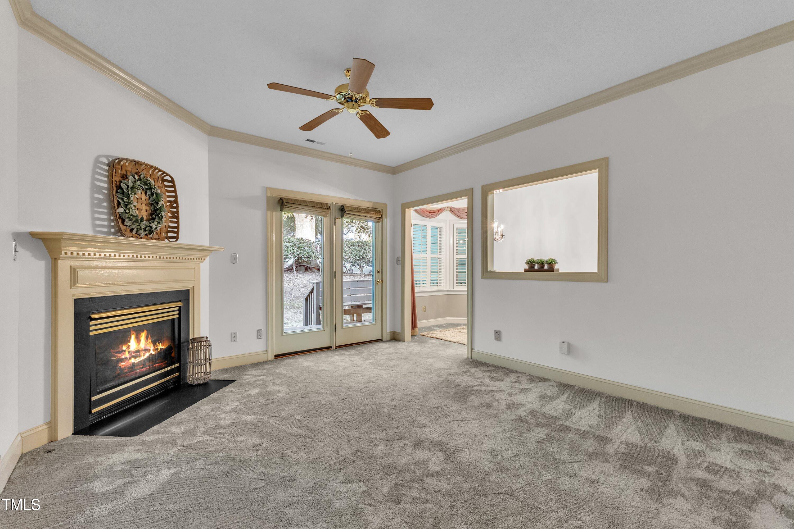 1210 Shadow Bark Court Raleigh, NC 27603 - Photo 5 of 32 a view of empty room with fireplace and fan