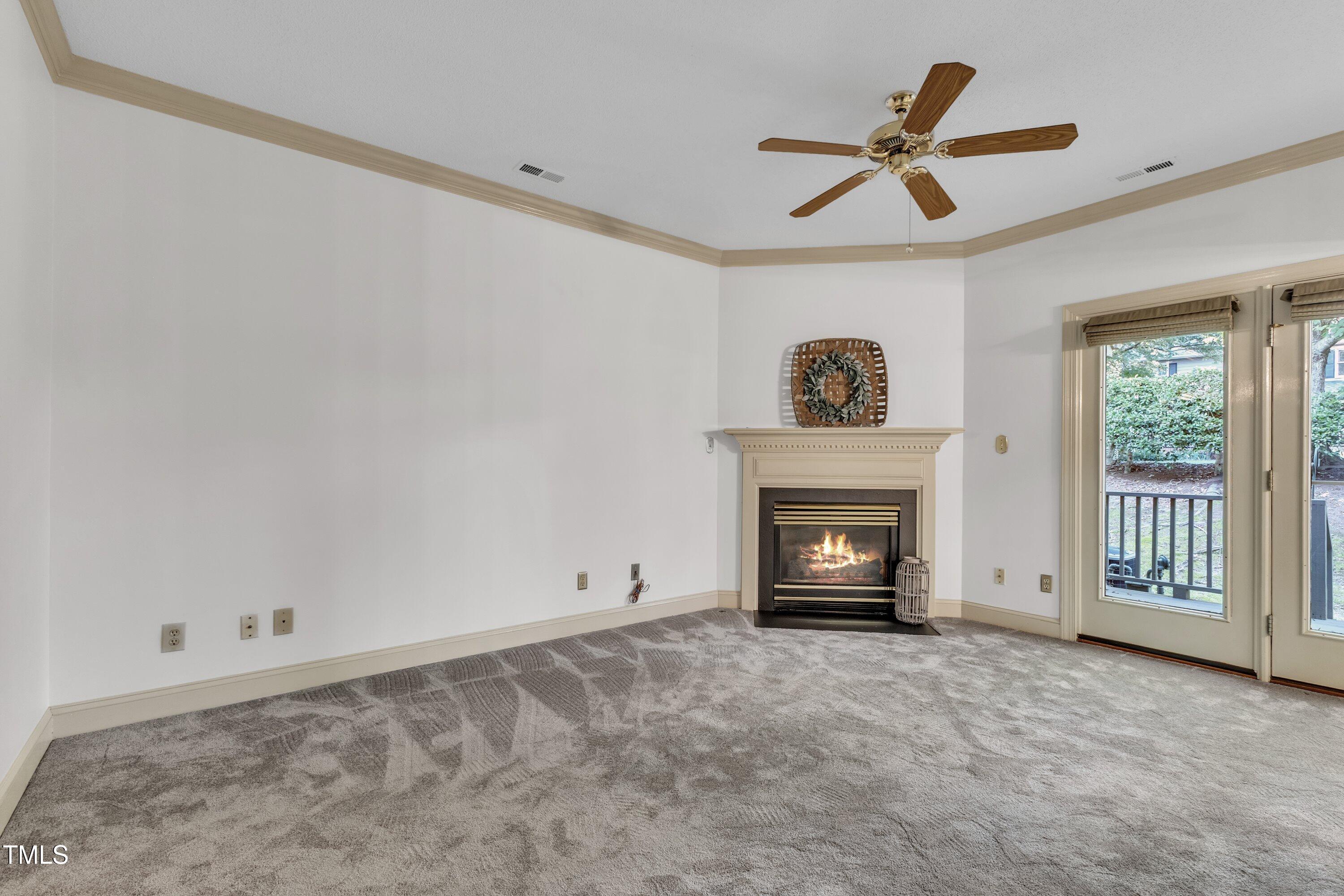 1210 Shadow Bark Court Raleigh, NC 27603 - Photo 7 of 32 a view of an empty room with a fireplace and a window