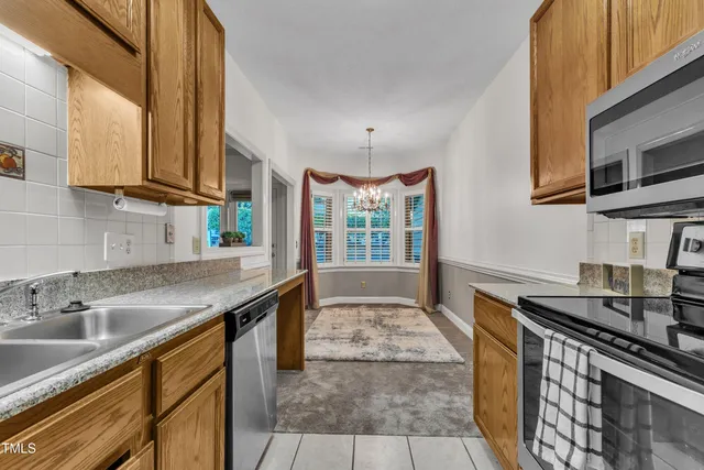 a kitchen with stainless steel appliances granite countertop a sink stove and cabinets
