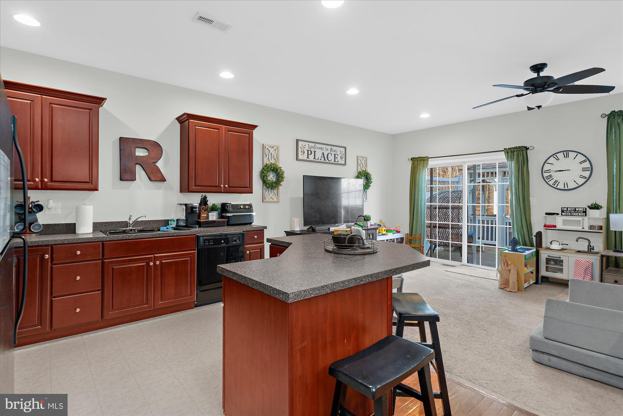 64 Sugar Maple Road Barto, PA 19504 - Photo 8 of 28 a open kitchen with stainless steel appliances granite countertop a stove a sink dishwasher and a refrigerator with wooden cabinets