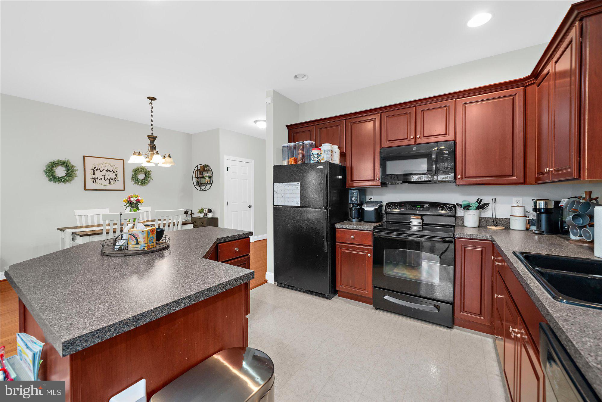 64 Sugar Maple Road Barto, PA 19504 - Photo 9 of 28 a kitchen with stainless steel appliances granite countertop a sink stove and refrigerator