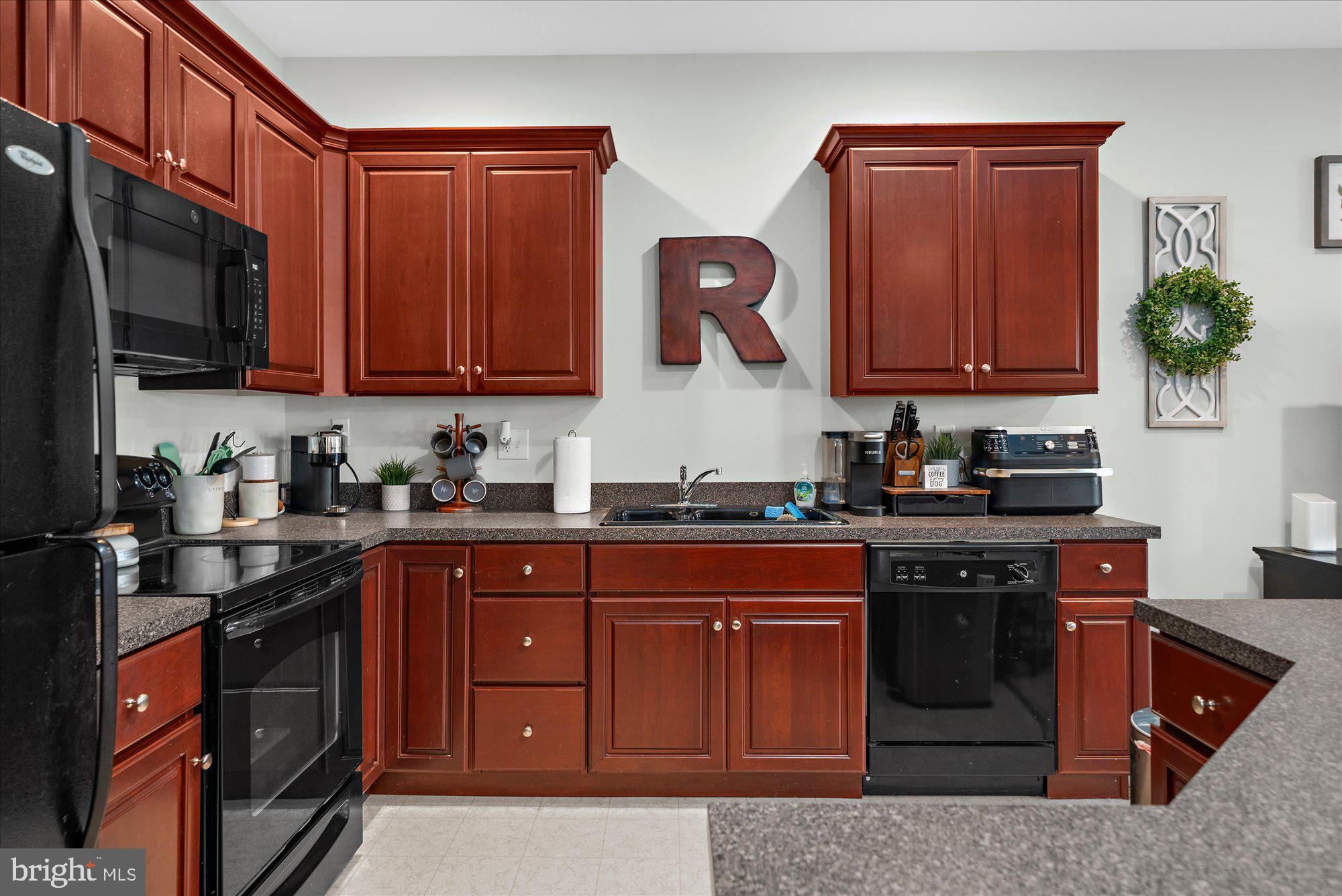 64 Sugar Maple Road Barto, PA 19504 - Photo 10 of 28 a kitchen with stainless steel appliances granite countertop a stove a sink dishwasher and cabinets with wooden floor