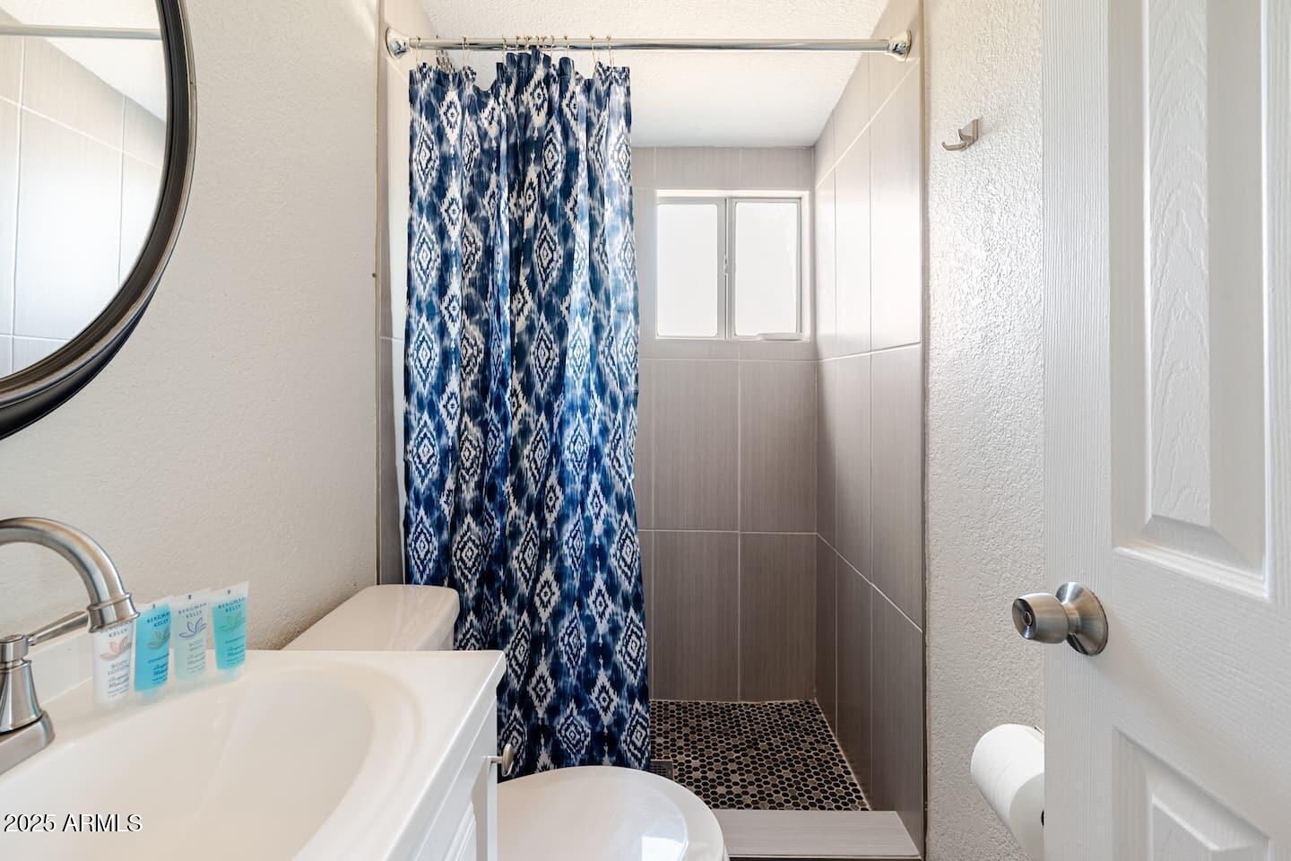 1514 East Fillmore Street Phoenix, AZ 85006 - Photo 11 of 24 a bathroom with a sink toilet and shower