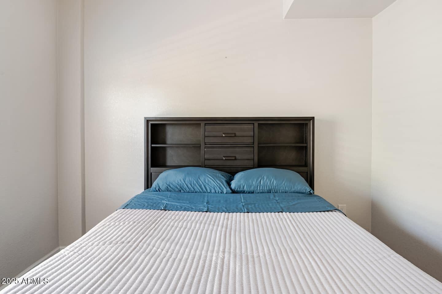 1514 East Fillmore Street Phoenix, AZ 85006 - Photo 14 of 24 a bedroom with a bed and a window