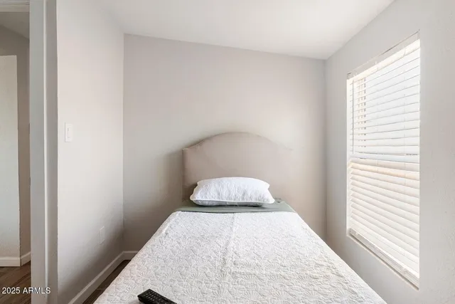 a bedroom with a bed and a window