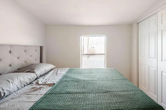 a bedroom with a bed and a window