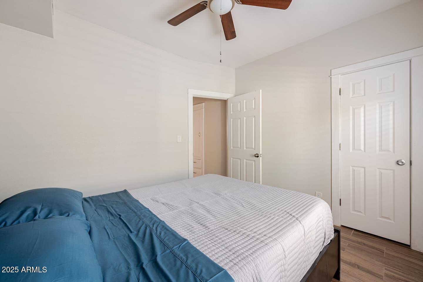 1514 East Fillmore Street Phoenix, AZ 85006 - Photo 18 of 24 a bedroom with a bed and wooden floor