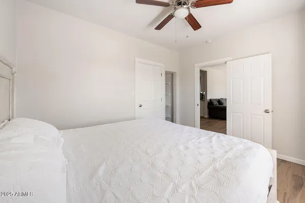 a view of a bedroom with a bed and cabinets
