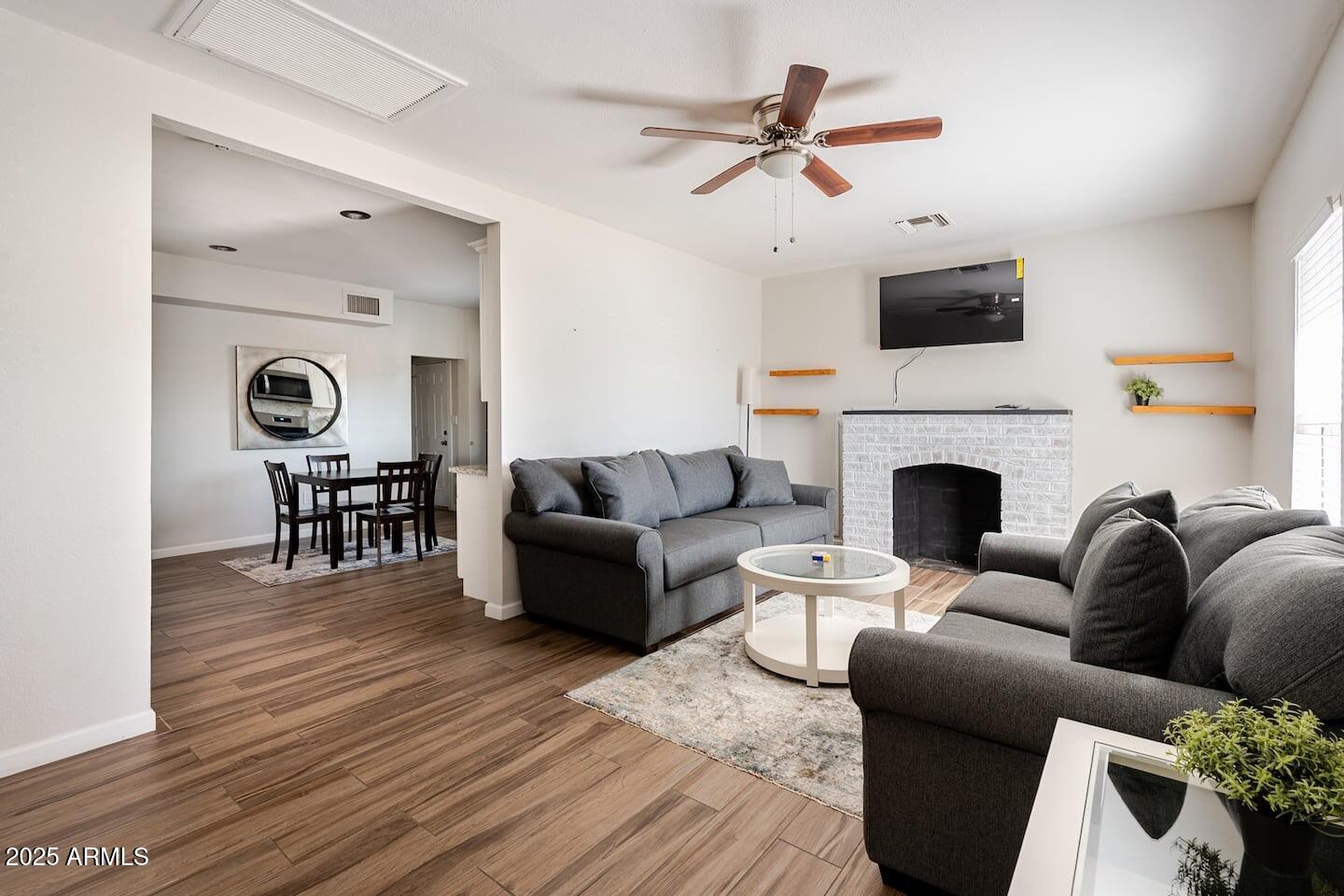 1514 East Fillmore Street Phoenix, AZ 85006 - Photo 5 of 24 a living room with furniture and a fireplace