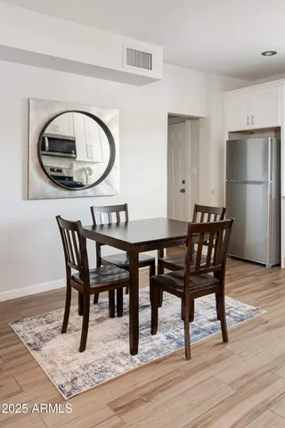 a view of a dining room with furniture and wooden floor