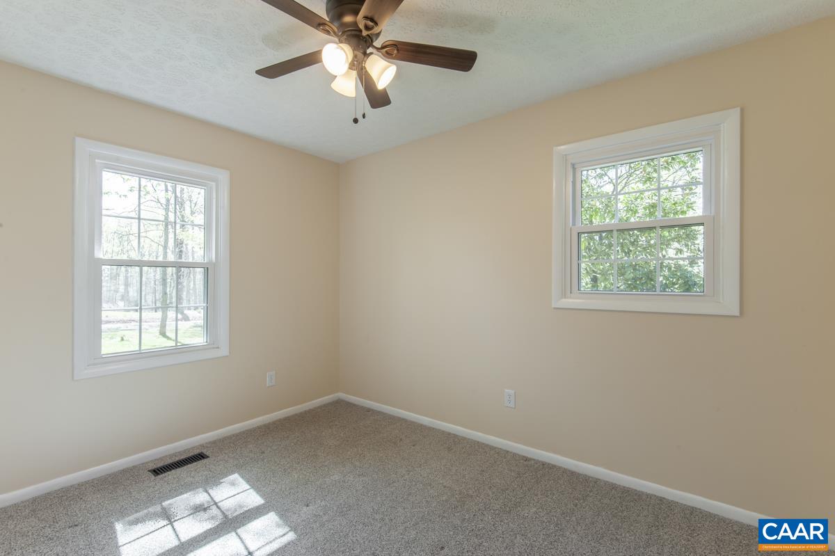 8882 James River Road Shipman, VA 22971 - Photo 19 of 50 an empty room with a window and a fan