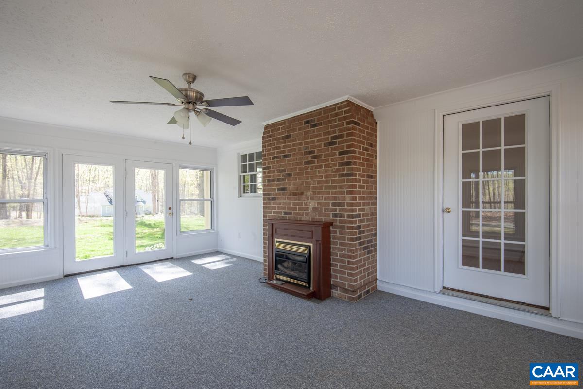 8882 James River Road Shipman, VA 22971 - Photo 22 of 50 a view of an empty room with a fireplace and a window