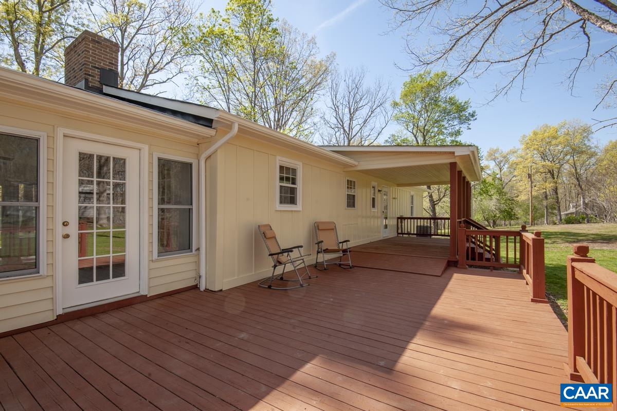8882 James River Road Shipman, VA 22971 - Photo 24 of 50 a view of a patio with table and chairs with wooden floor and fence