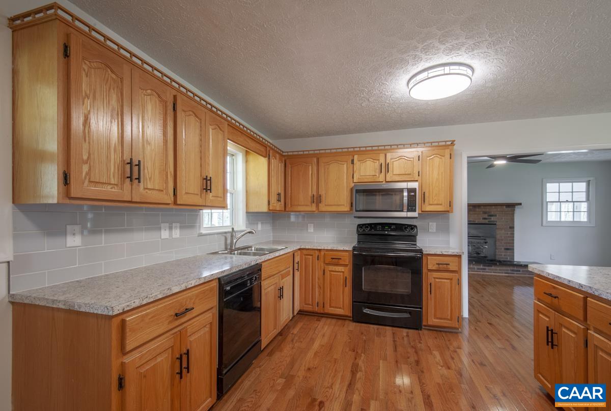 8882 James River Road Shipman, VA 22971 - Photo 3 of 50 a kitchen with stainless steel appliances granite countertop a stove a sink and a refrigerator