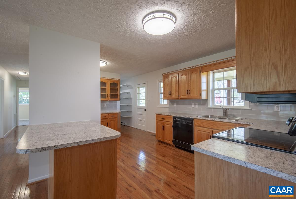 8882 James River Road Shipman, VA 22971 - Photo 4 of 50 a kitchen with stainless steel appliances granite countertop wooden cabinets and a granite counter tops