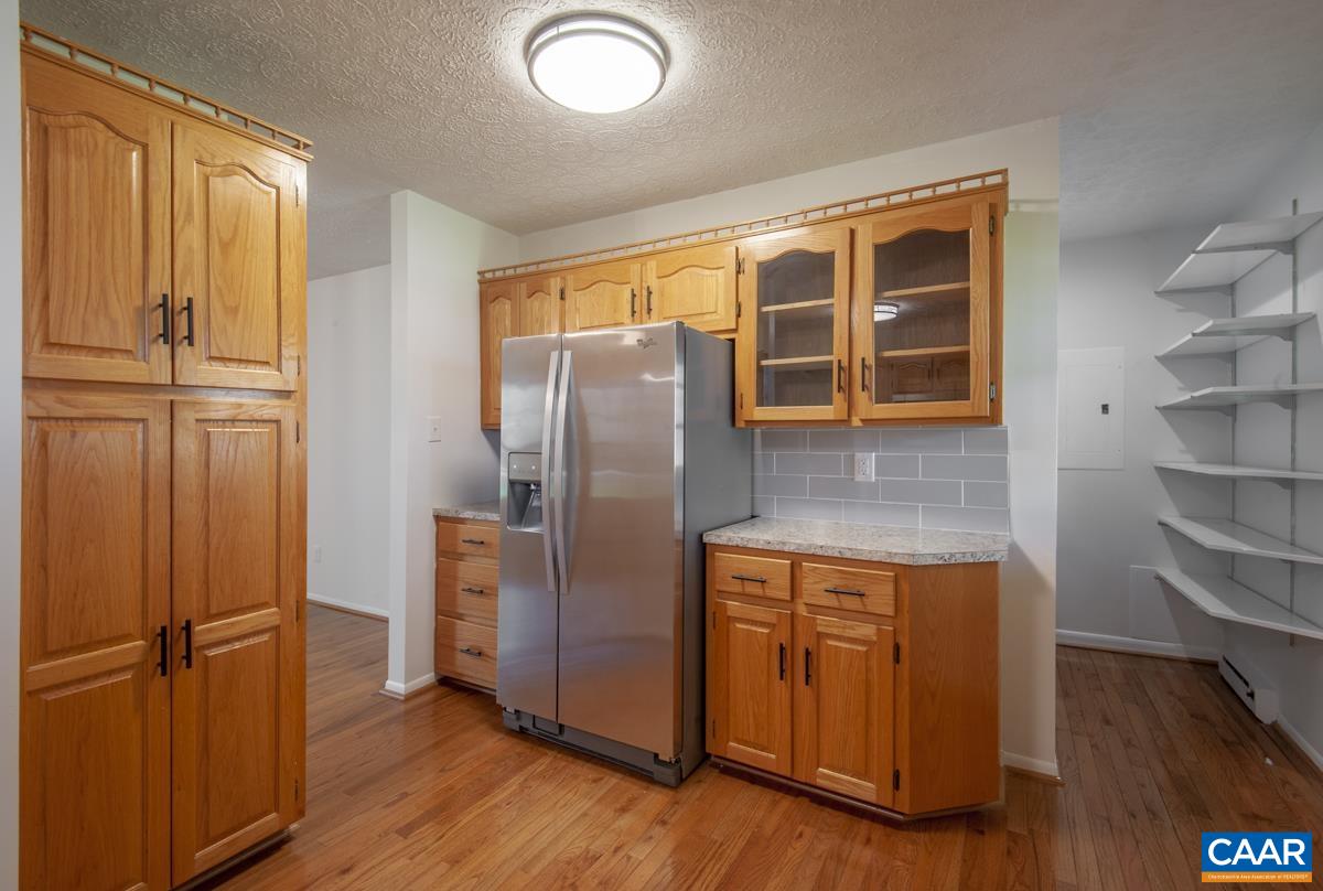 8882 James River Road Shipman, VA 22971 - Photo 6 of 50 a kitchen with kitchen island a counter top space and a refrigerator